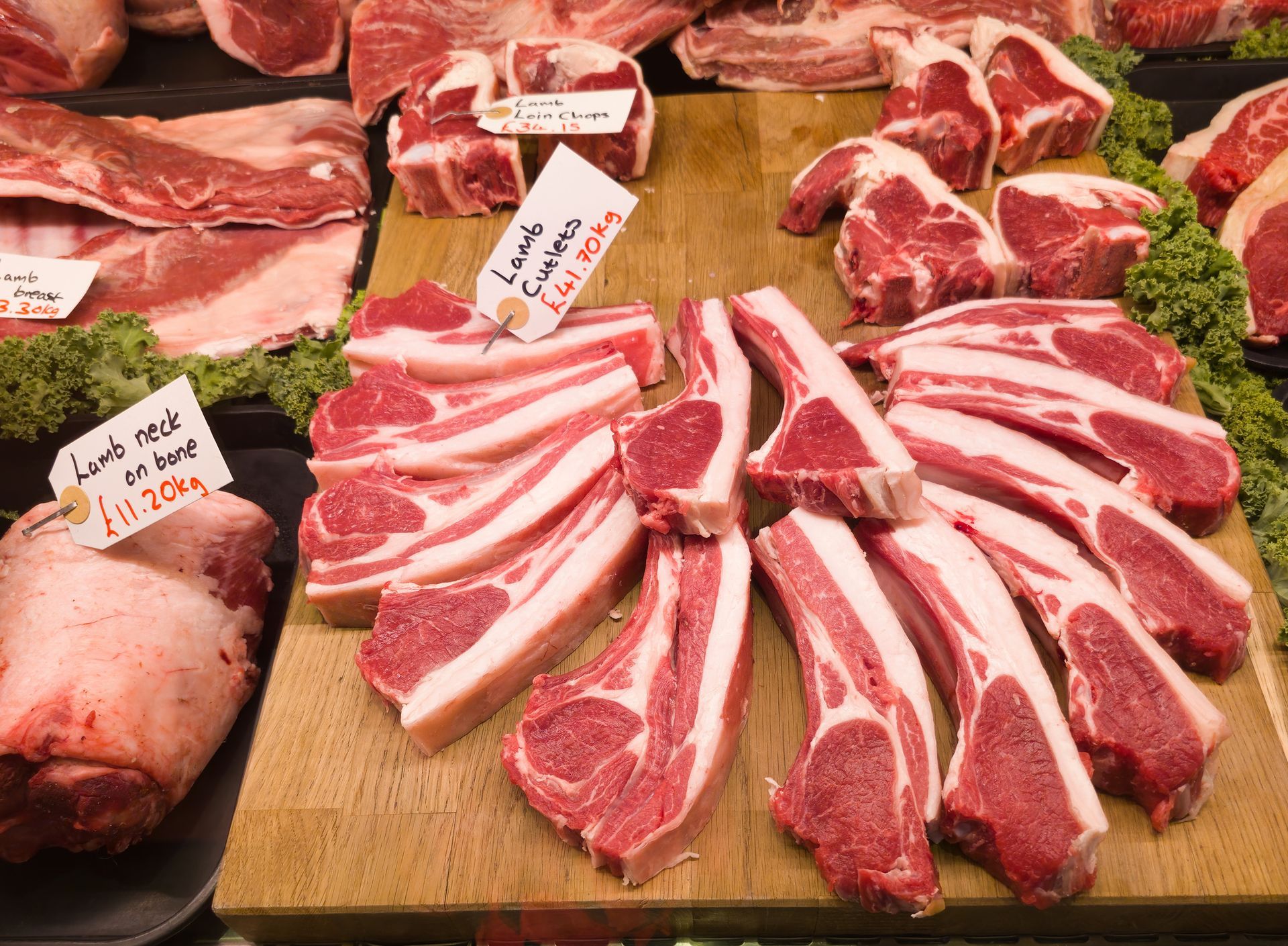 A display of lamb chops on a wooden cutting board