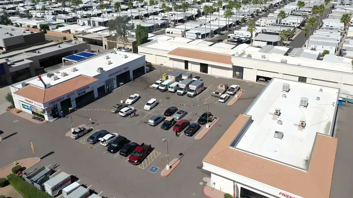 An aerial view of a parking lot filled with cars. | Friendly Auto Centers