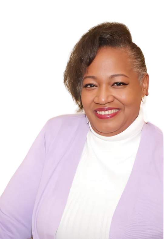 Woman in a lavender cardigan and white turtleneck smiles, looking directly at the camera.