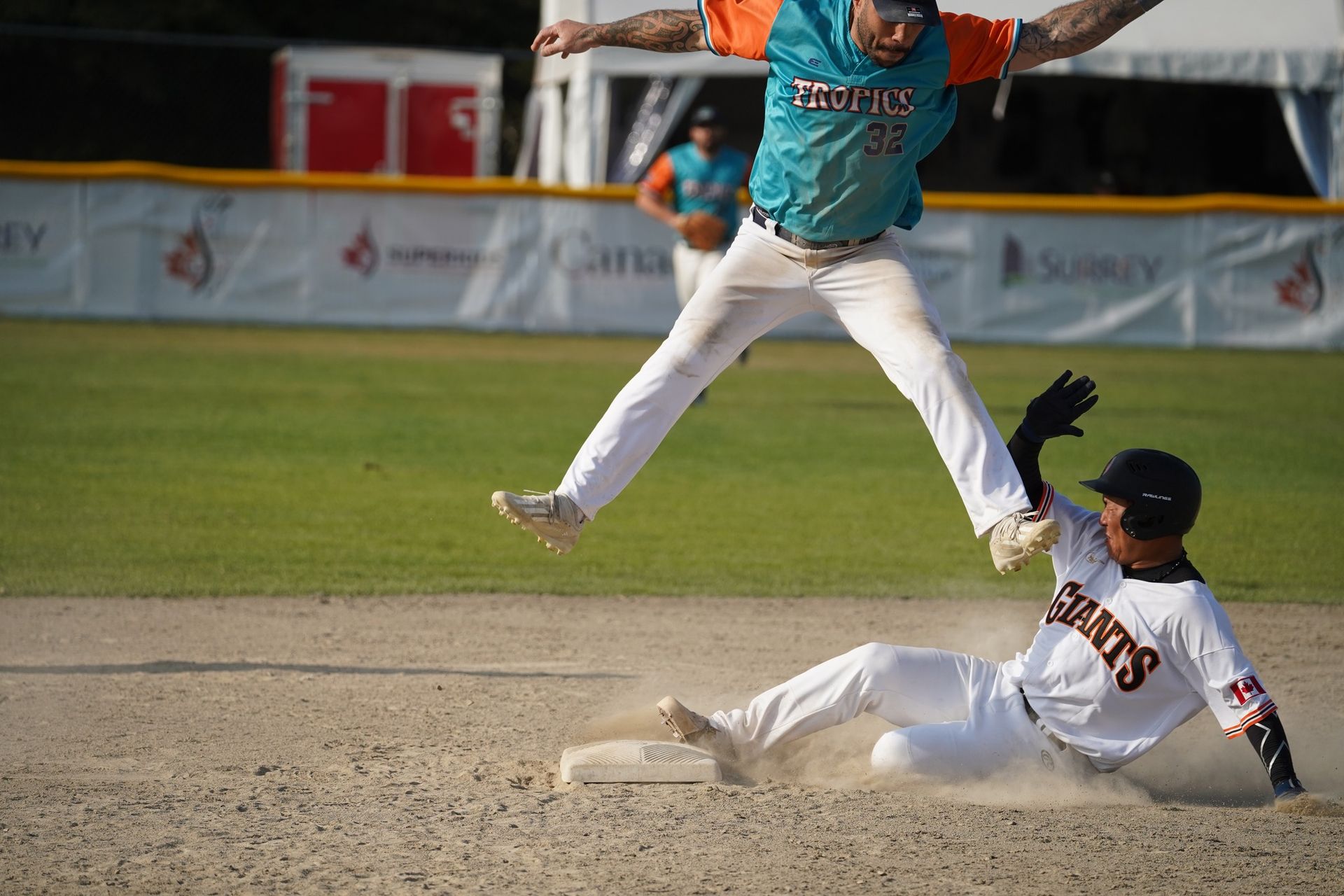 Ryan King jumps over a Giants player at second base