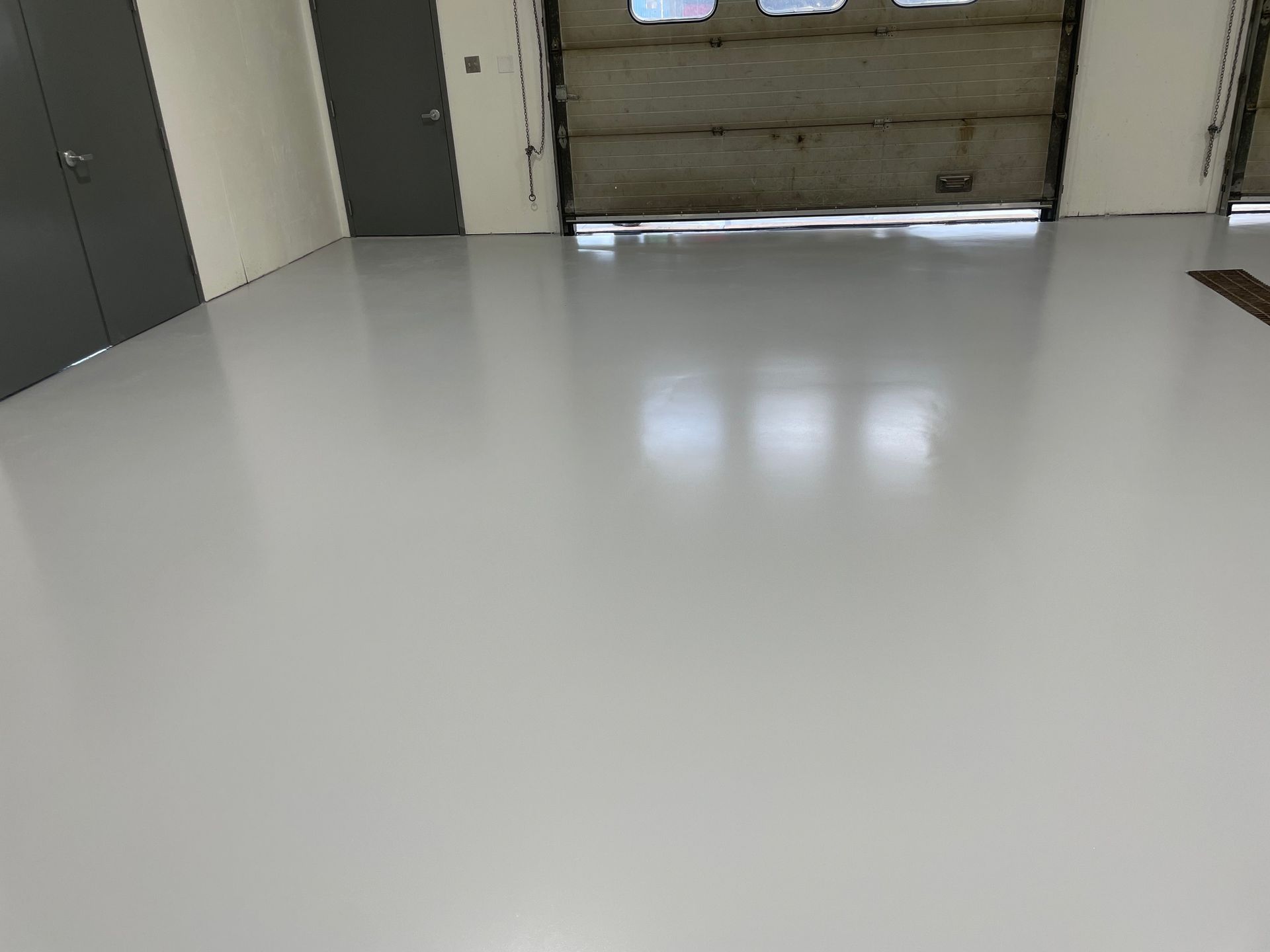 Light Gray Solid Color Epoxy Garage floor with trench drain 