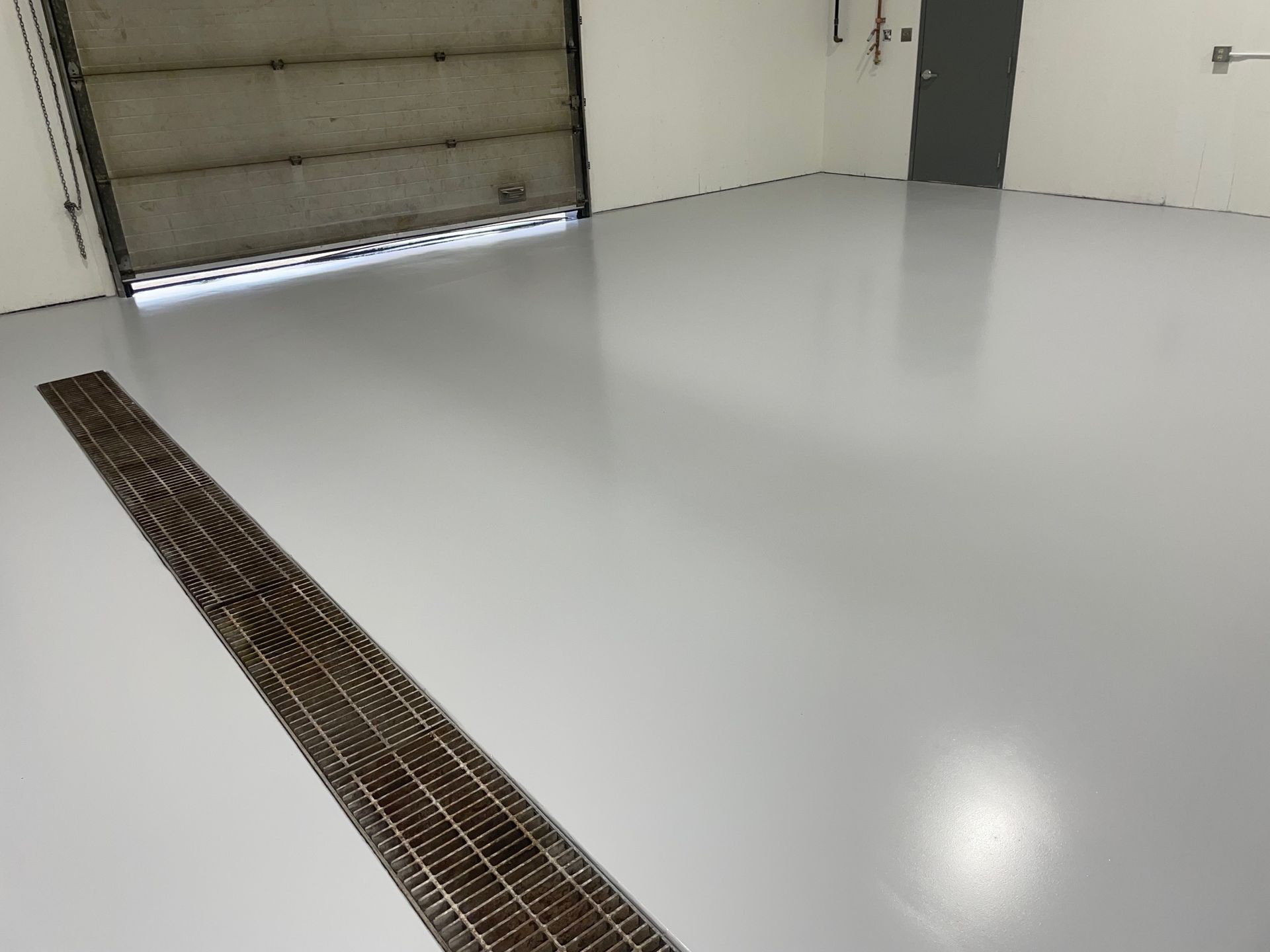 Light Gray Solid Color Epoxy Garage floor with trench drain 