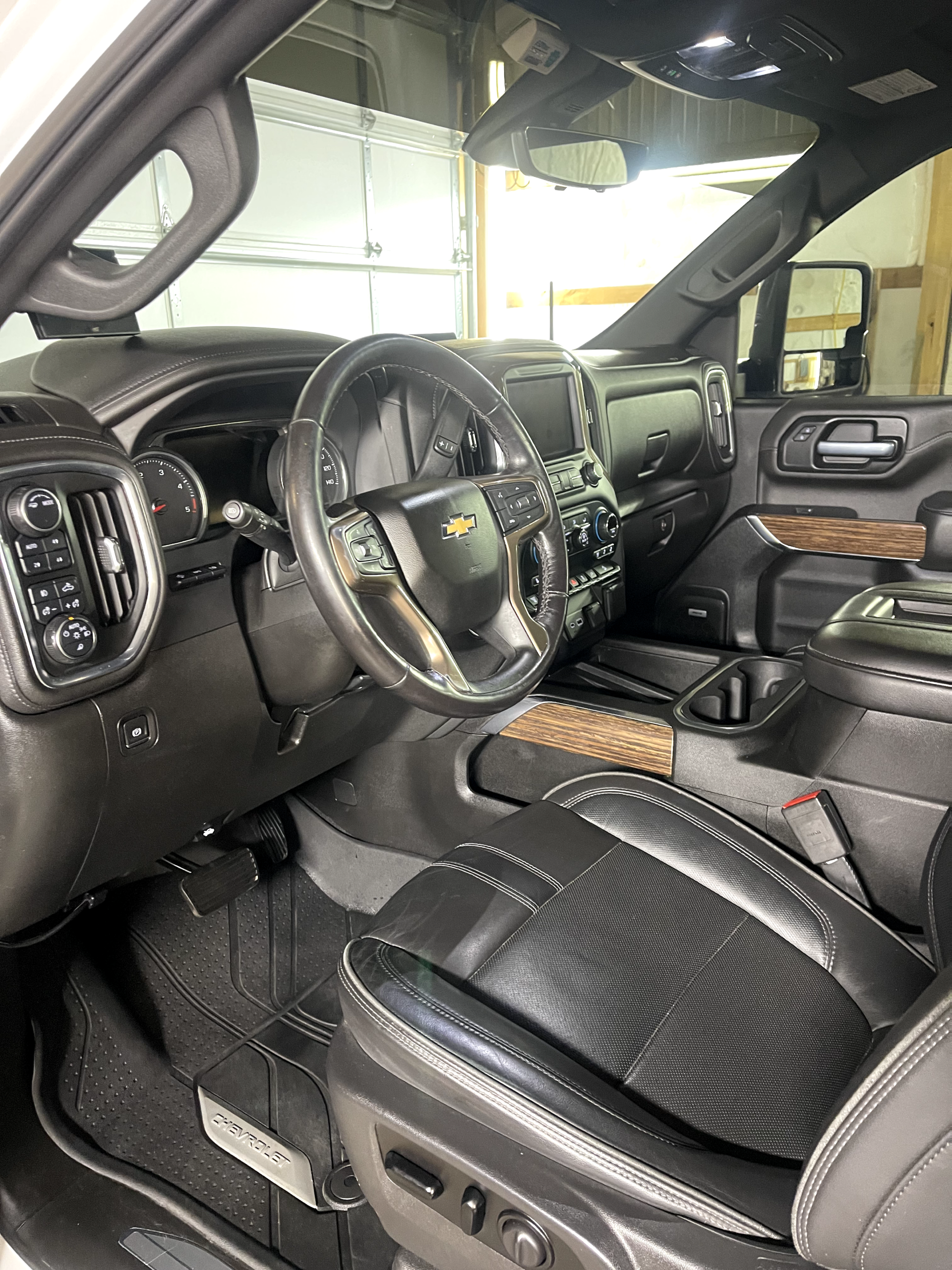 the interior of a white truck with black seats and a steering wheel .
