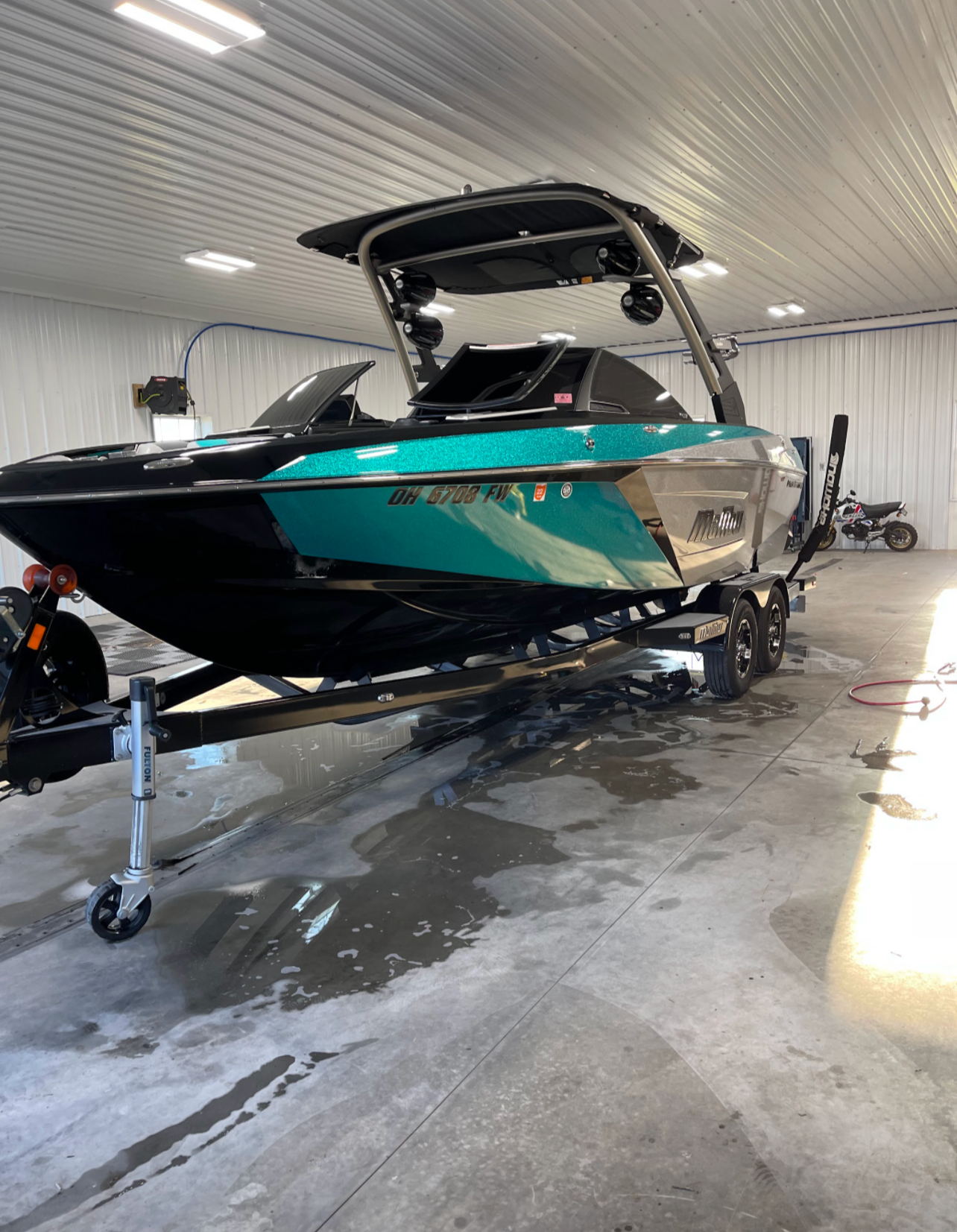 a boat is sitting on a trailer in a garage .