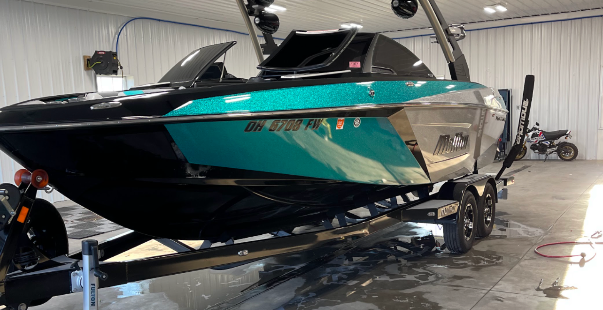 a boat is sitting on a trailer in a garage .