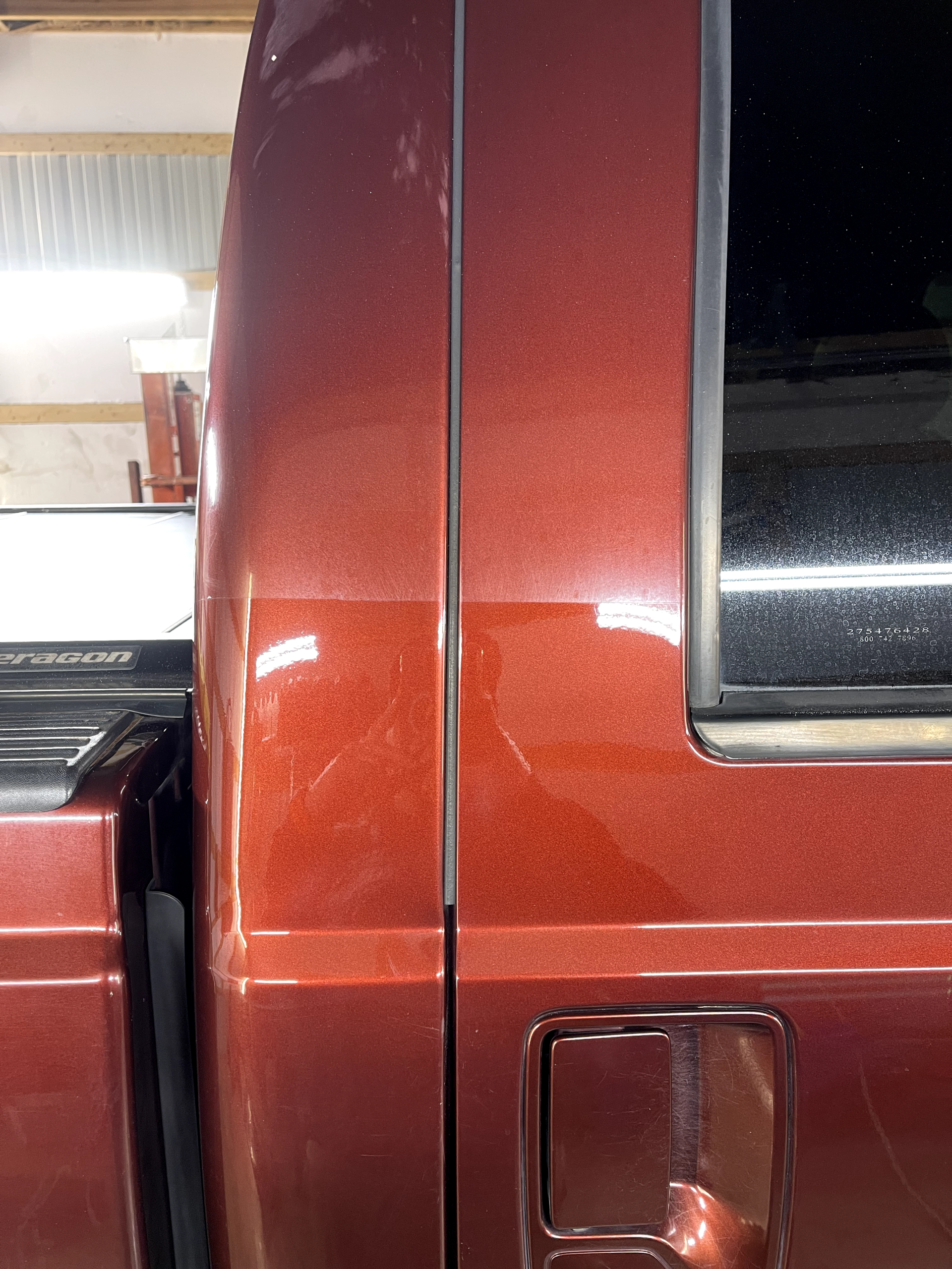 a red truck is parked in a garage with the door open