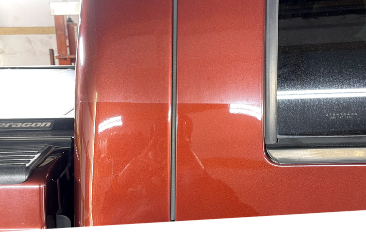 a red truck is parked next to a black truck