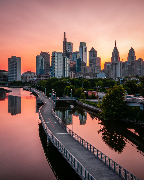 A living room with a couch , chairs , coffee table , fireplace and television.