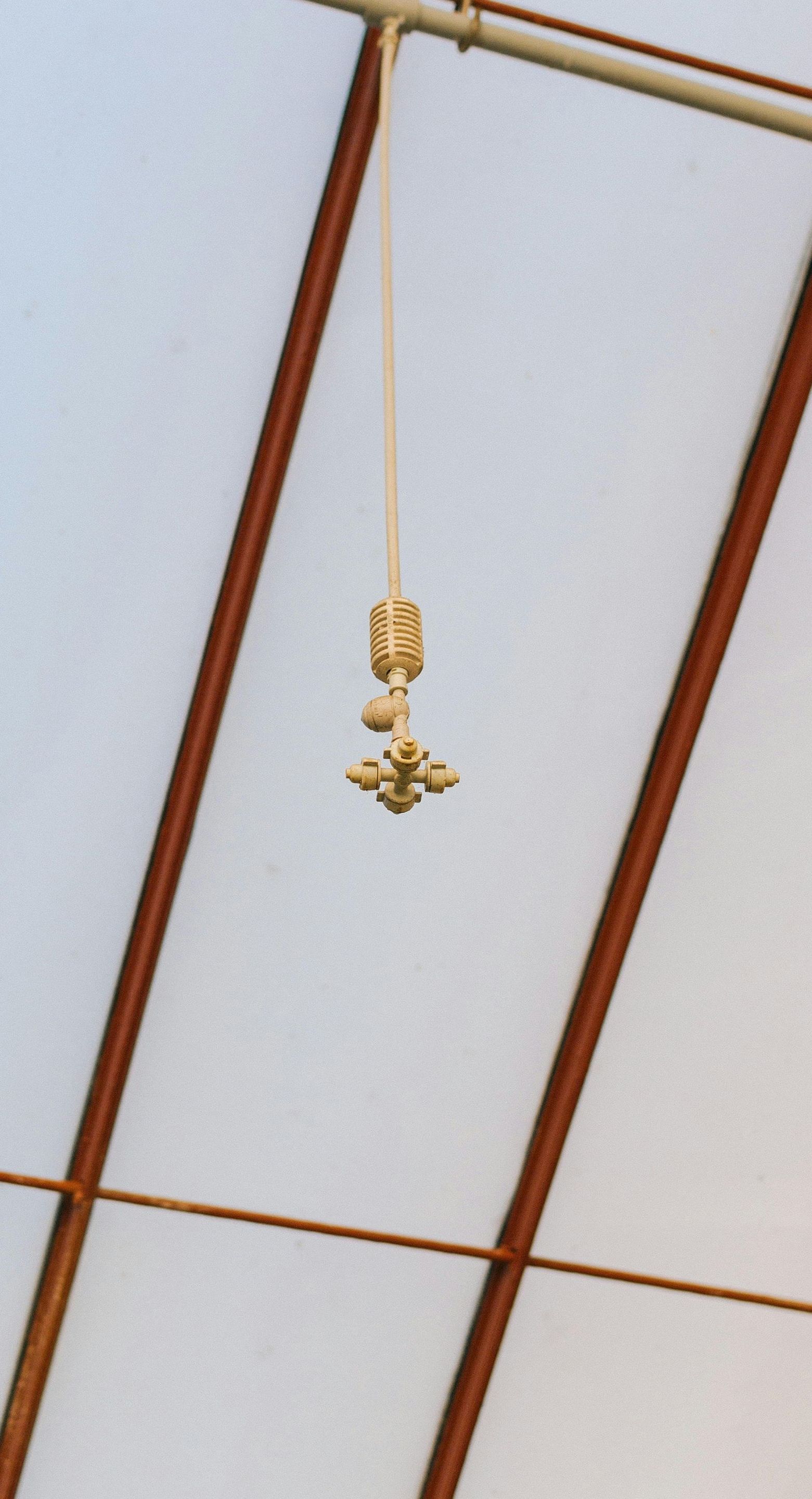 A cross is hanging from the ceiling of a building