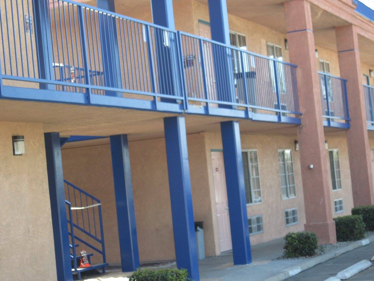 A building with a blue railing and stairs