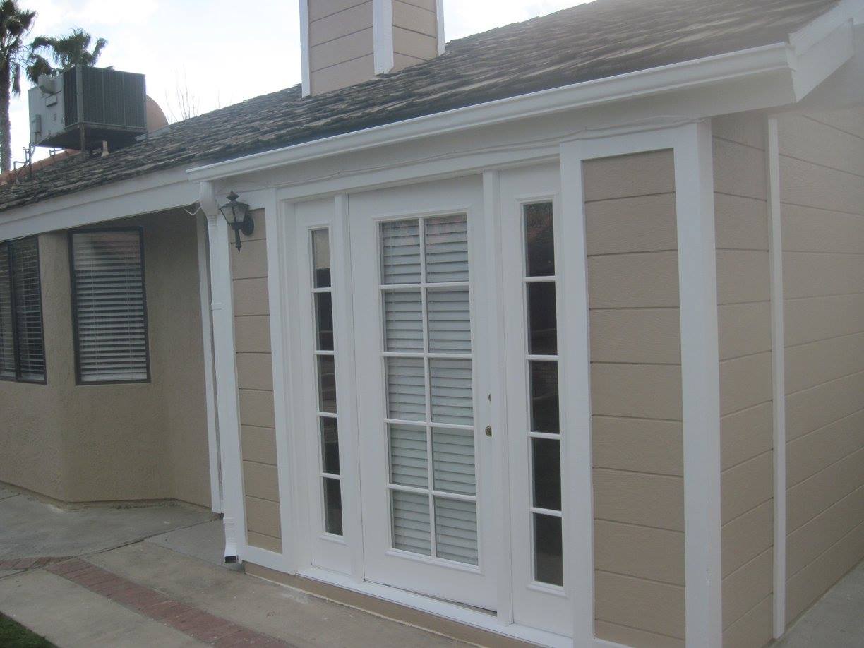 A house with a porch and a sliding glass door