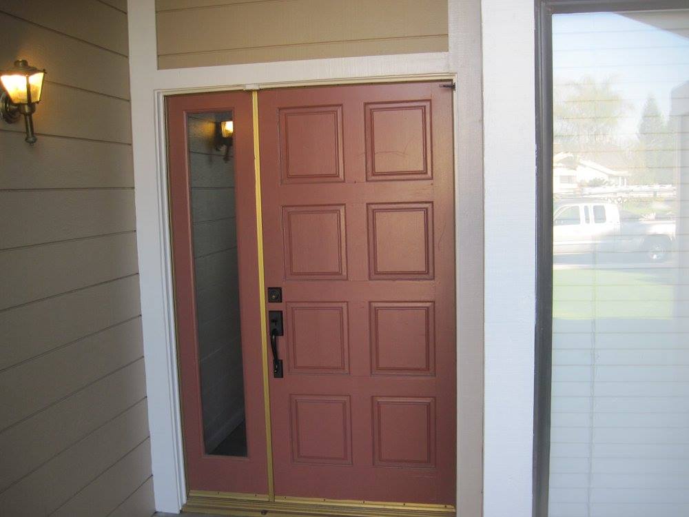 A red door with a gold trim and a window