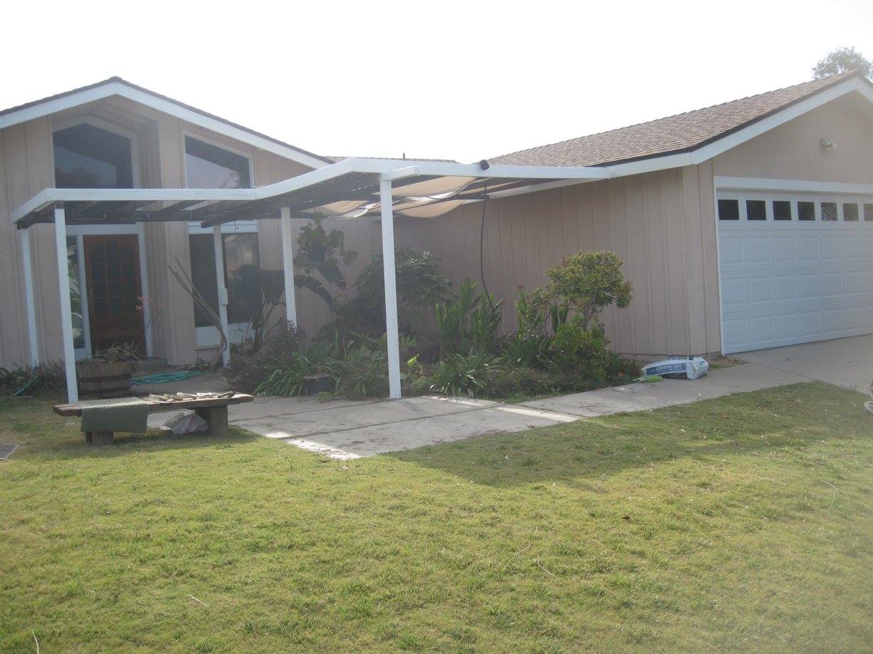 A house with a covered porch and a white garage door