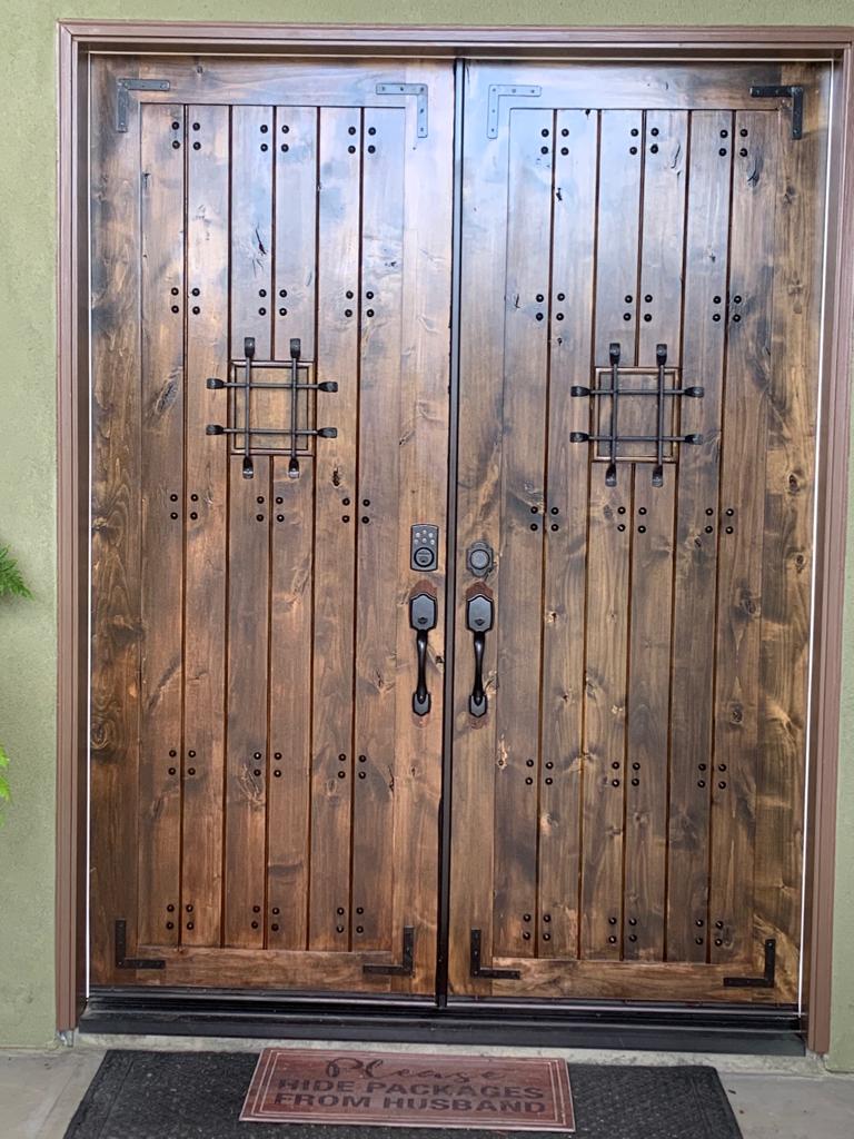 A wooden door with a welcome mat in front of it