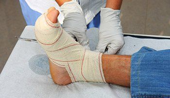Changing bandage to a patient foot