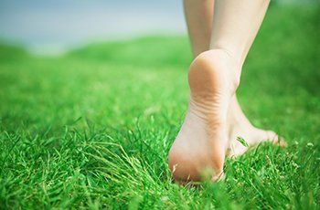 Woman legs on green grass