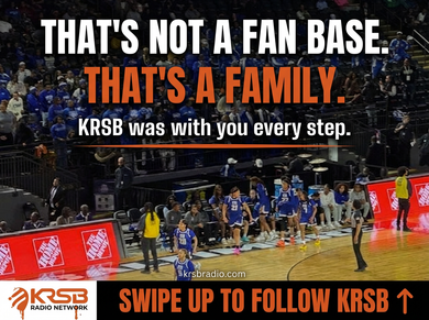 Woman in jeans and sneakers at a table, looking at phone. KRSB Network text with