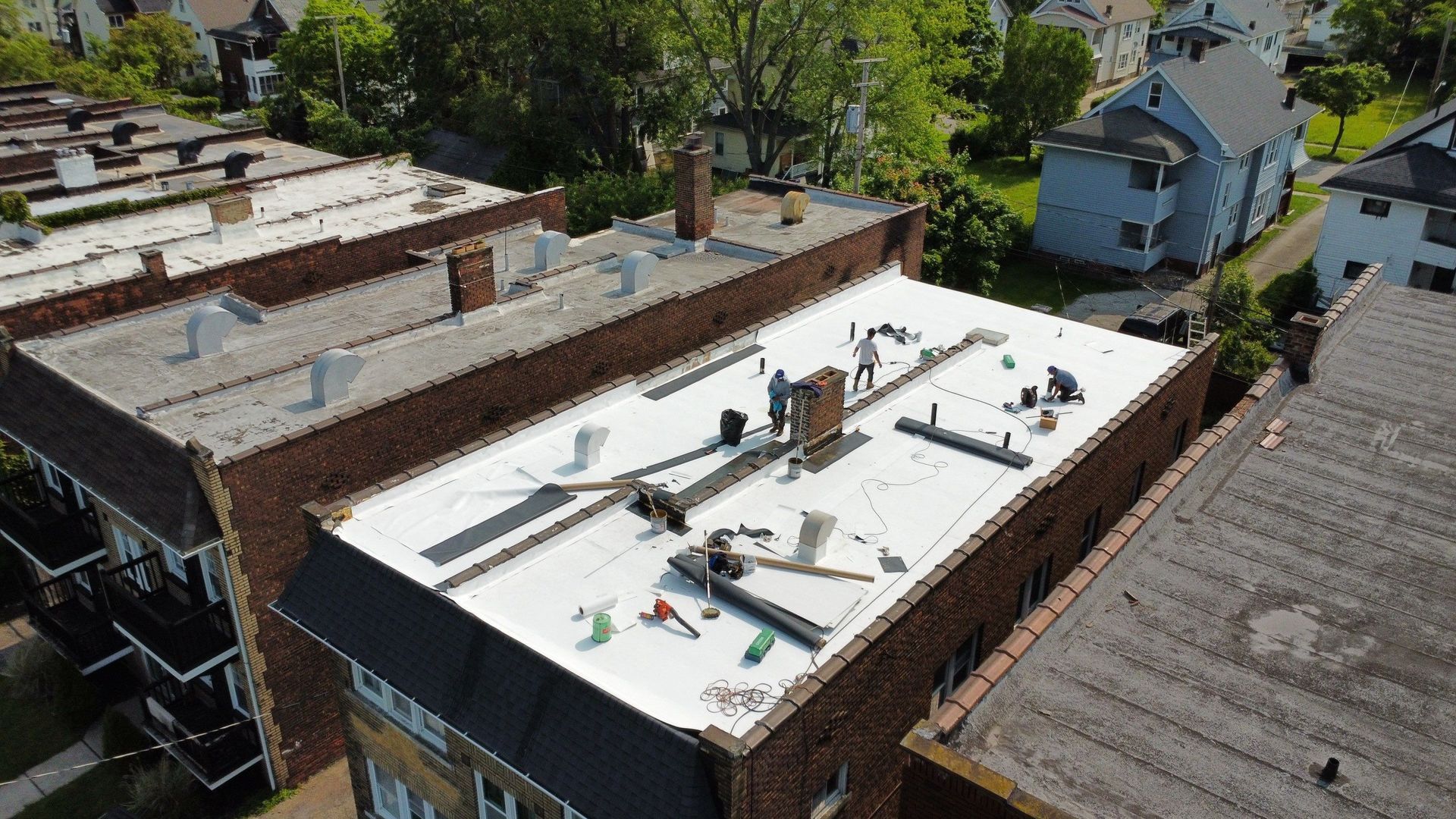 White Car Parked on The Side of A House — Cleveland, OH — Iman Roofing