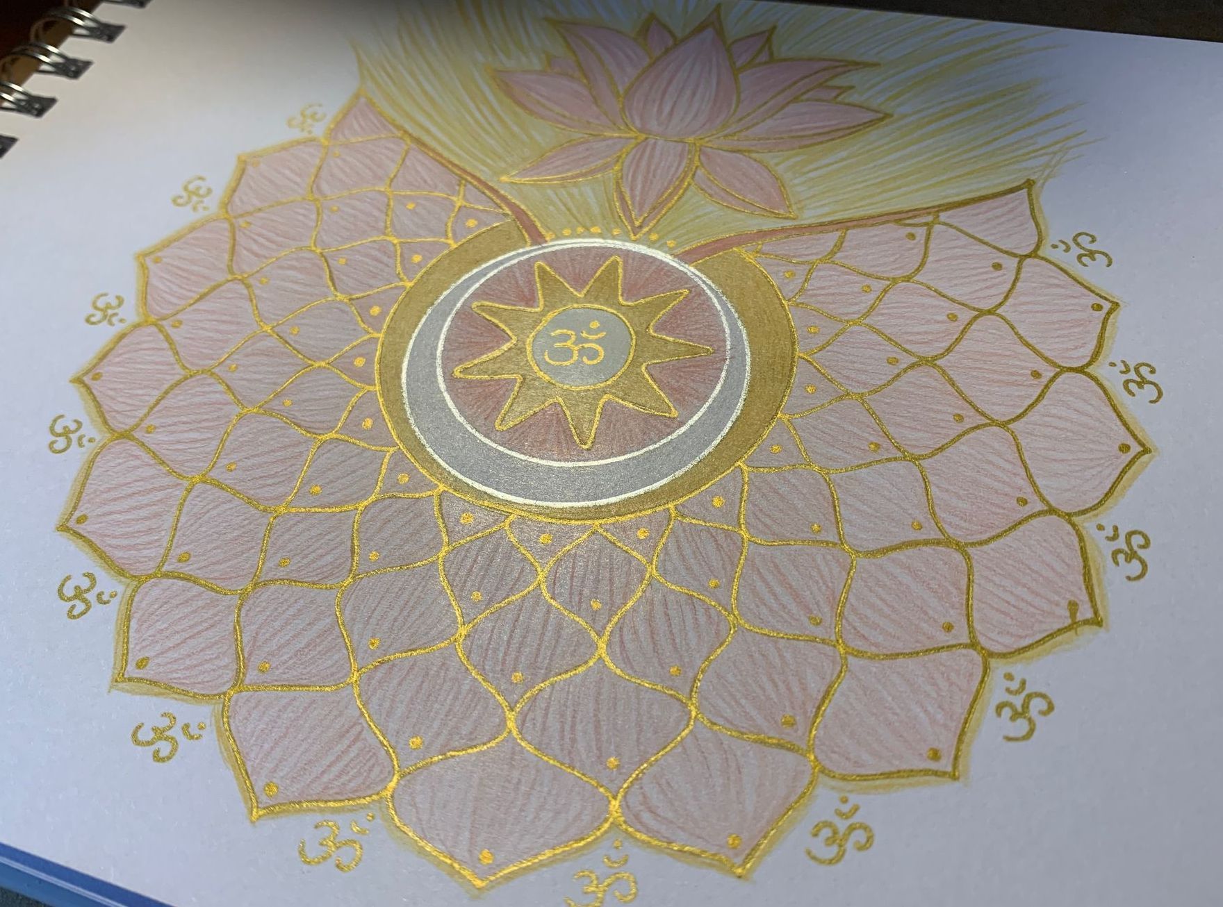 Pink and gold mandala with a lotus flower, OM symbol, and geometric patterns on white paper.