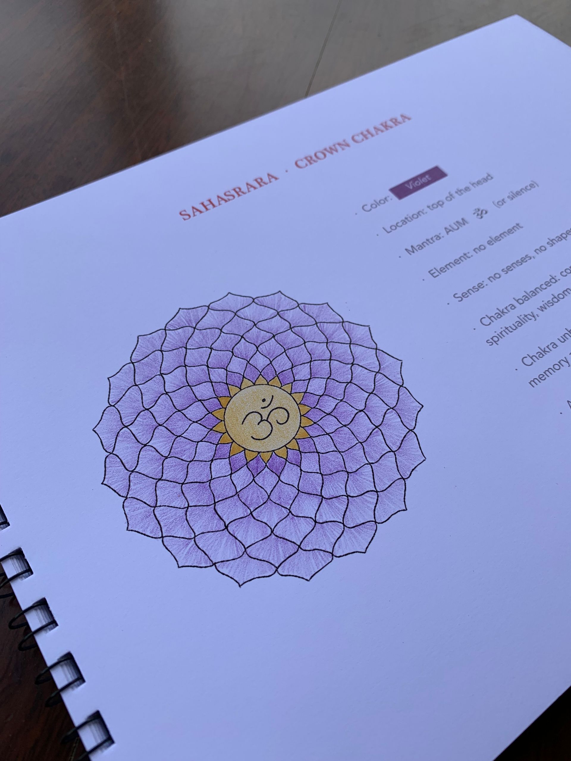 Page open to a purple Sahasrara Chakra diagram with a golden center.