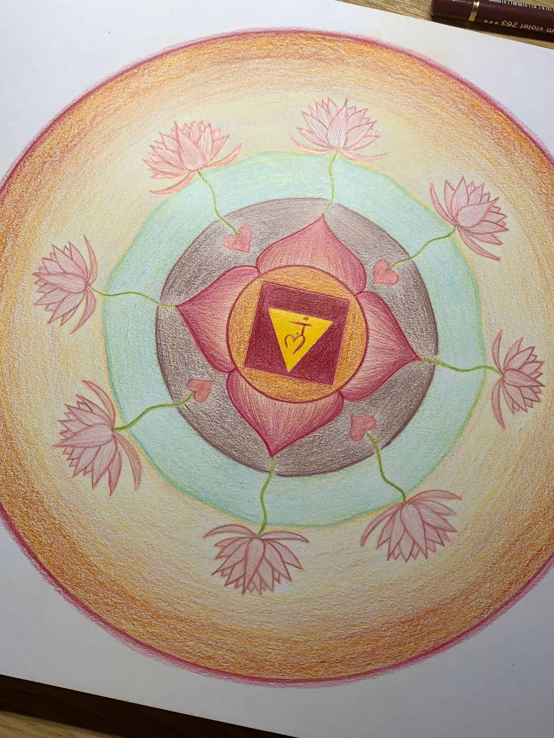 Colorful mandala with concentric circles, pink lotus flowers, and a central triangle.