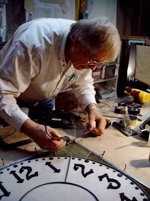 man fixing an old clock
