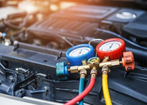 A Close Up Of A Car Engine With Gauges Attached To It — Too Ezy Auto Electrics In Townsville, QLD