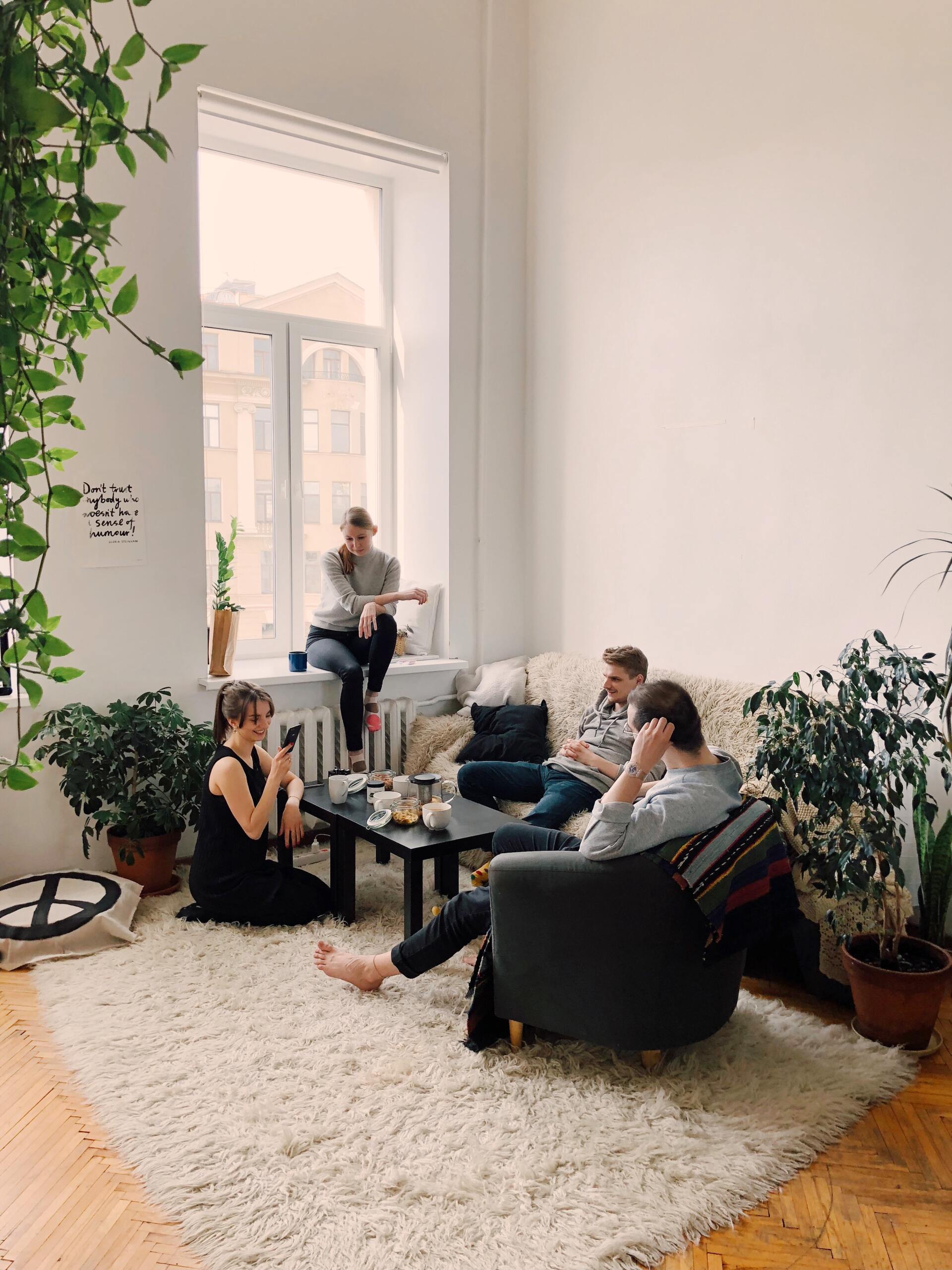 A group of young adults hanging out together in a homely living space