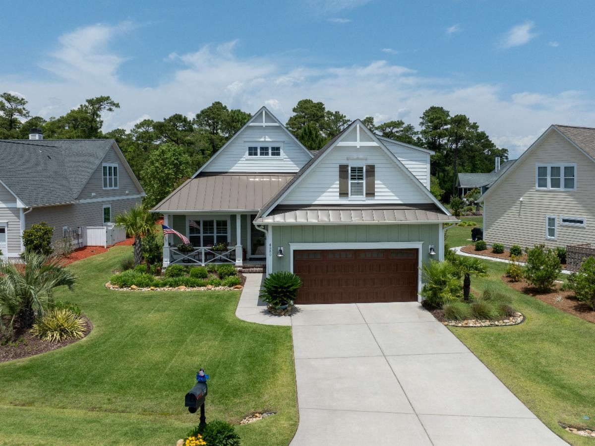 An aerial view of a house with a brown garage door | Buy A Home in St. James with Thomas McCloskey’s guidance