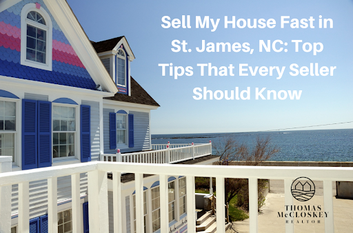 A coastal home with vibrant blue shutters and a balcony overlooking the ocean on a clear, sunny day.