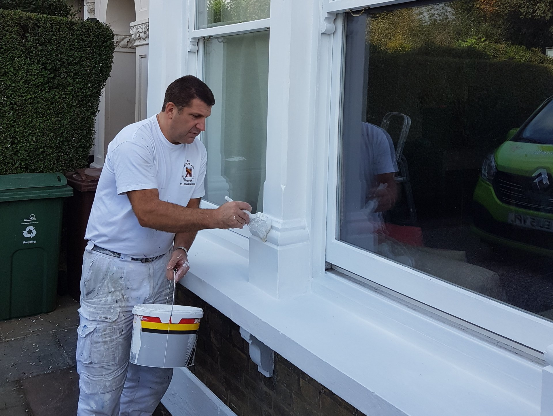 Man painting exterior windows