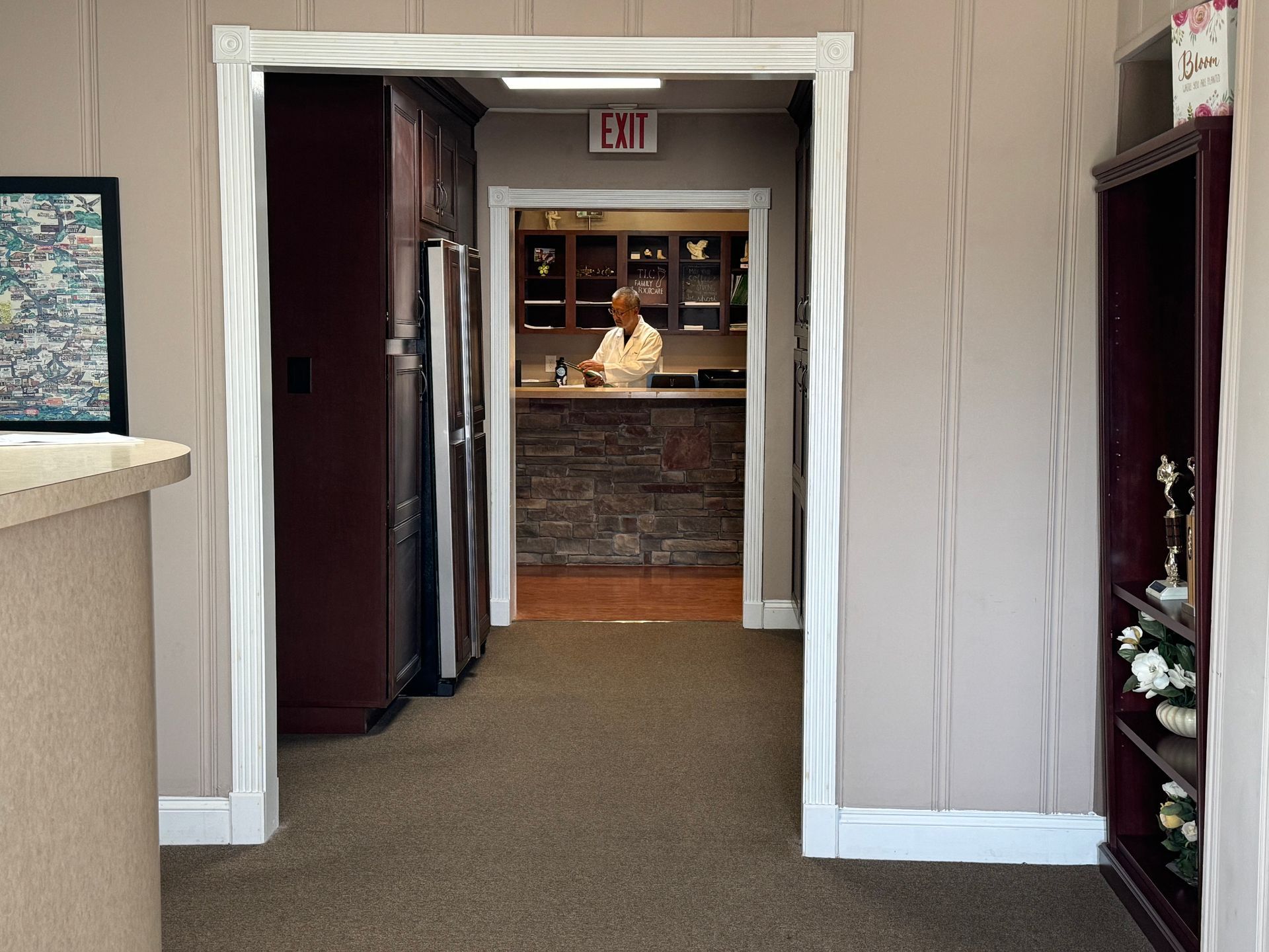 A woman is sitting on the edge of a pool with her feet in the water.