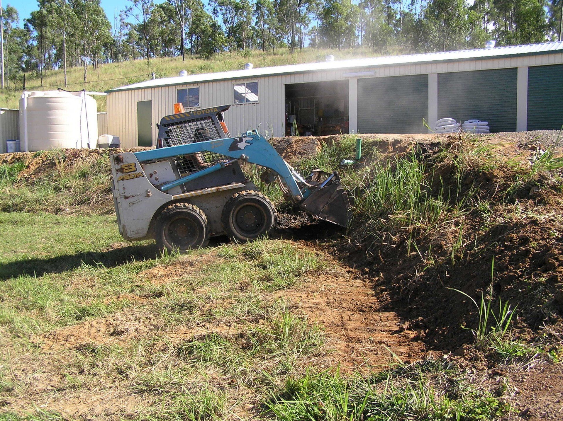 Bobcat Preparing Base for Rock Wall 2 — A1 Rock This City Truck & Dog Hire In Good Night QLD