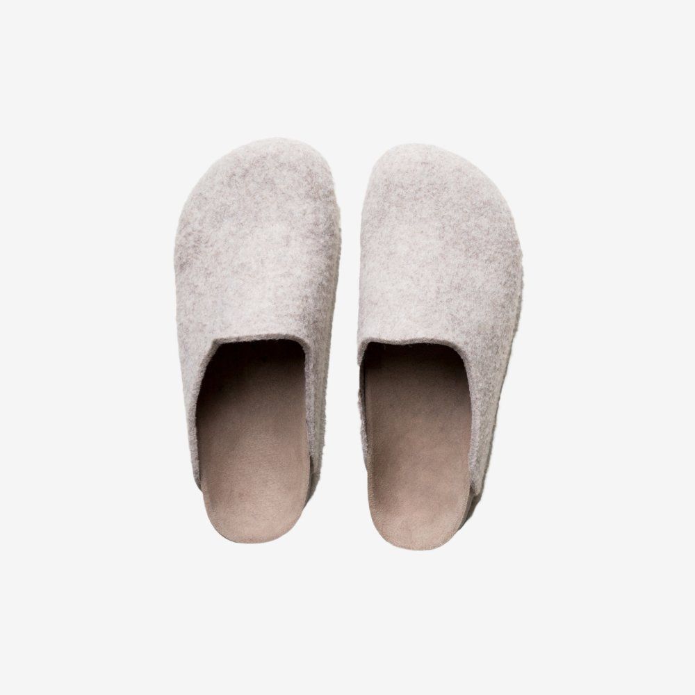 Pair of light gray felt clogs with tan soles, on a white background.
