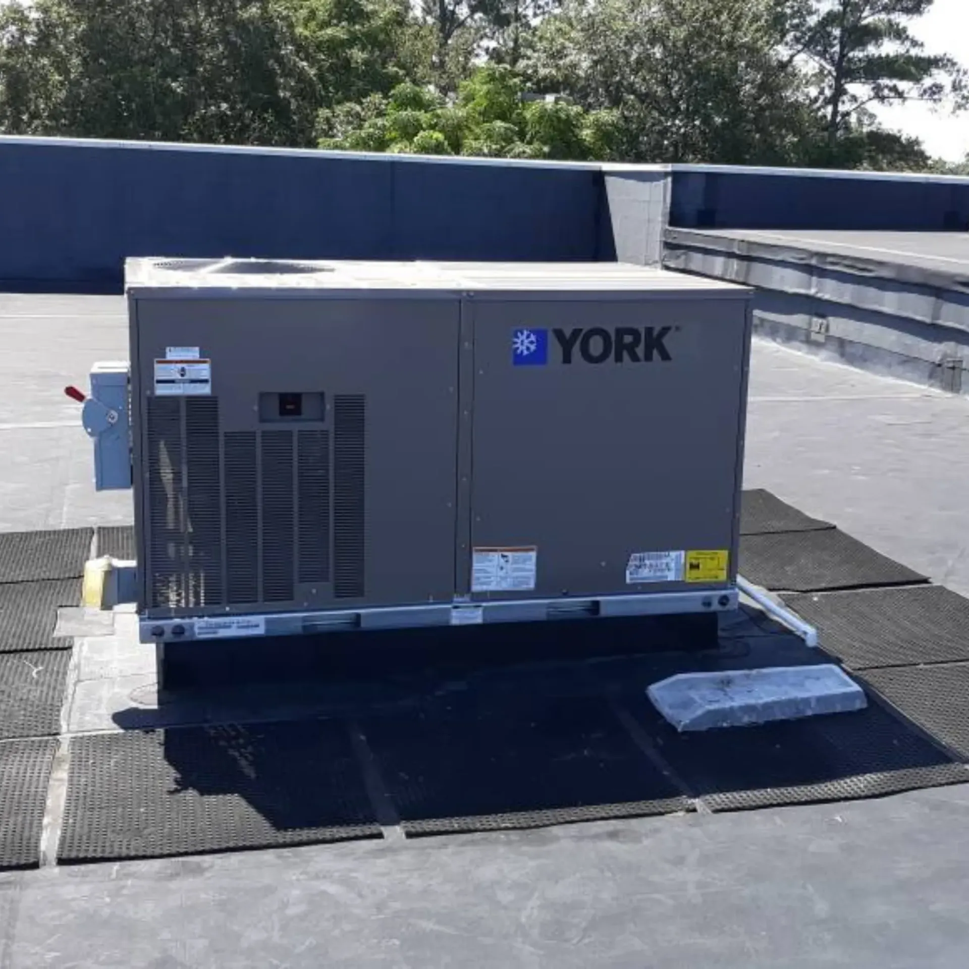 A york air conditioner is sitting on top of a roof