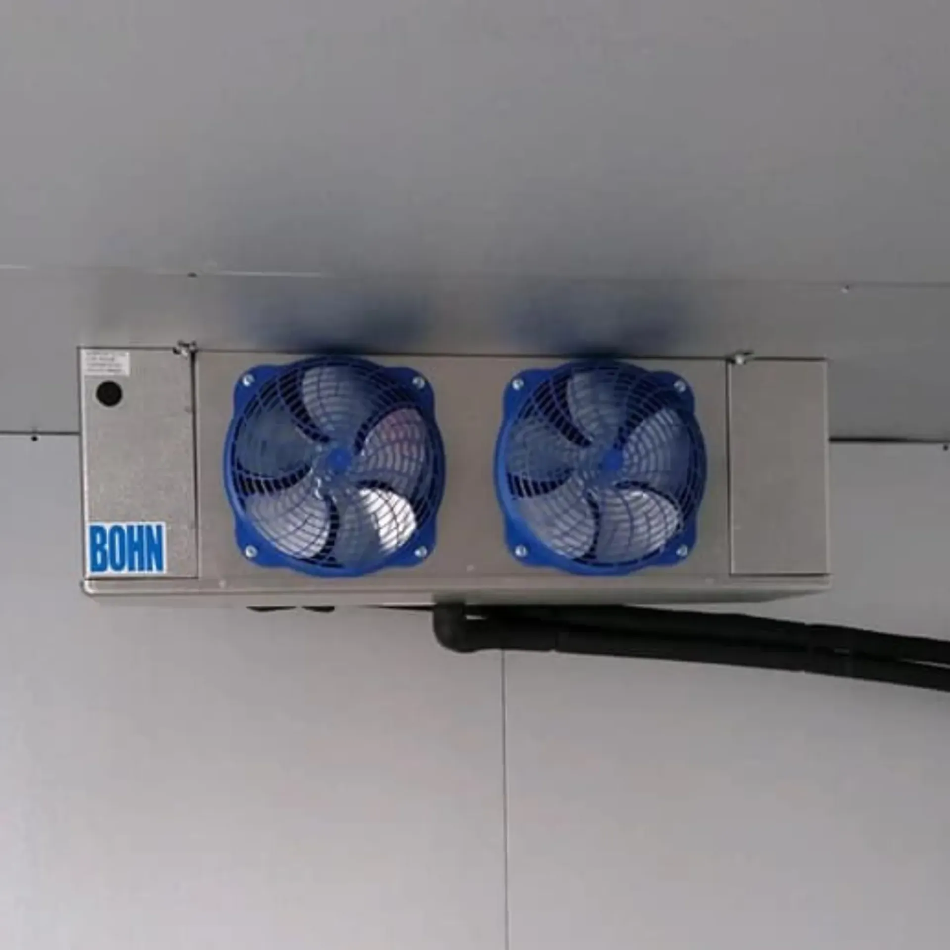 A stainless steel box with two blue fans attached to it.