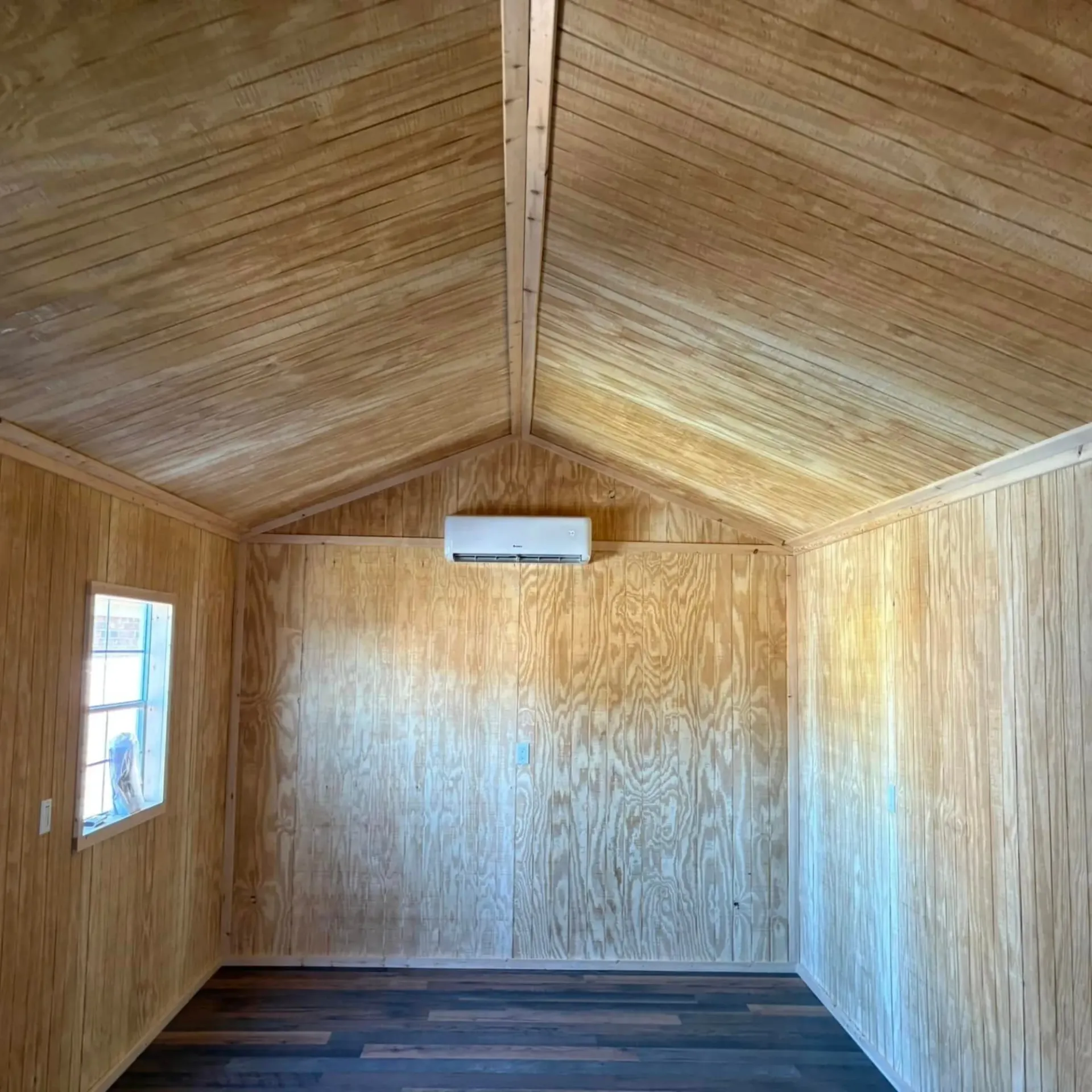 A room with a wooden ceiling and a window.