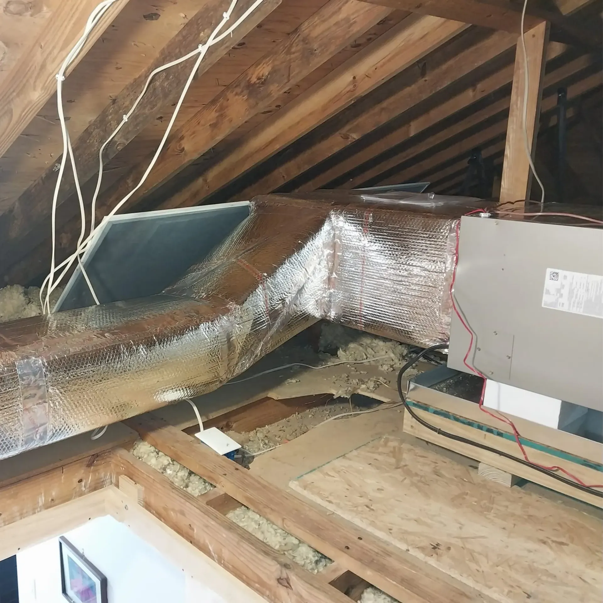 There is a duct in the attic that is being installed.