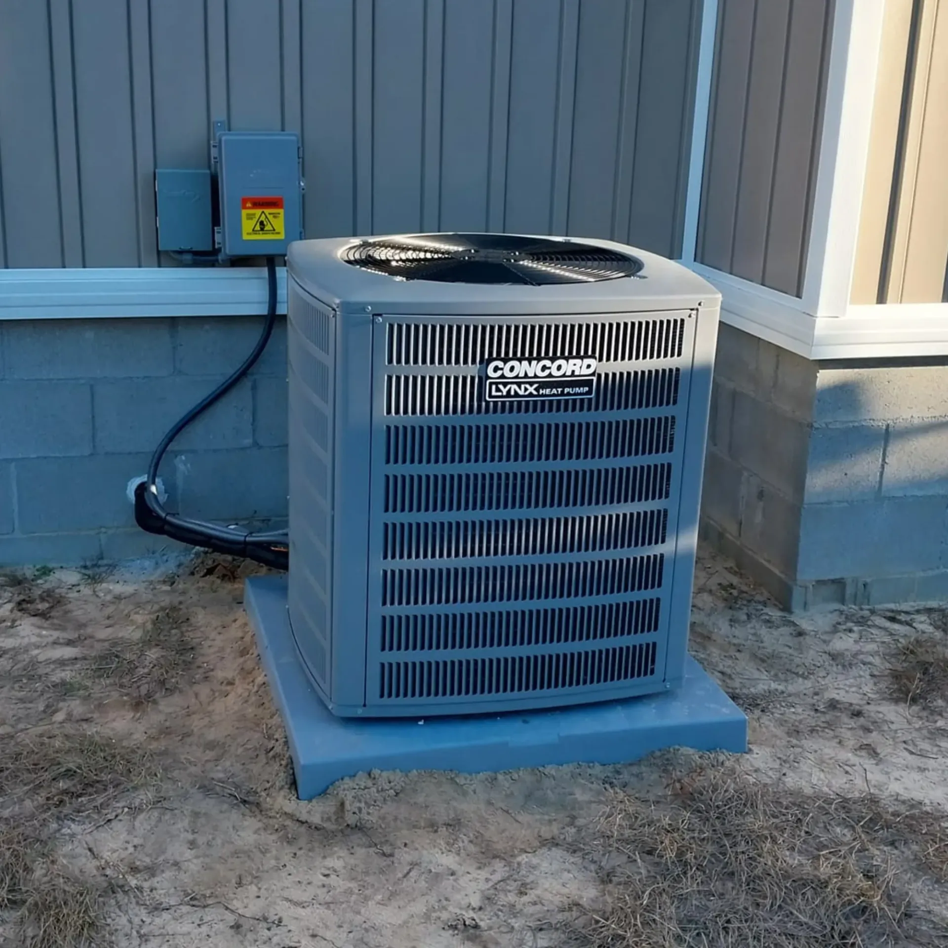 A concord air conditioner is sitting outside of a building
