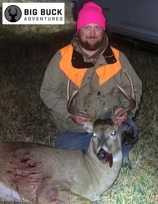 Hunter holding a dead deer after a successful hunt
