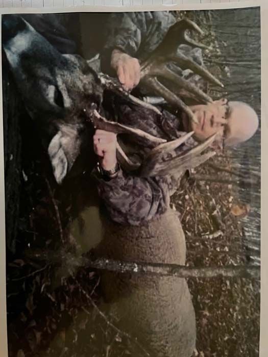 Hunter showing off his prized deer after a successful hunt