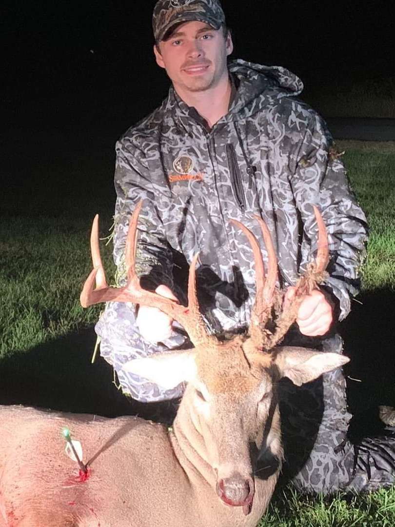 Hunter with a freshly killed deer on a cold morning hunt