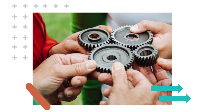 A group of people are holding gears in their hands.