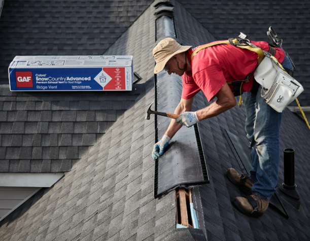 Red metal roof with white gutters and two skylights.
