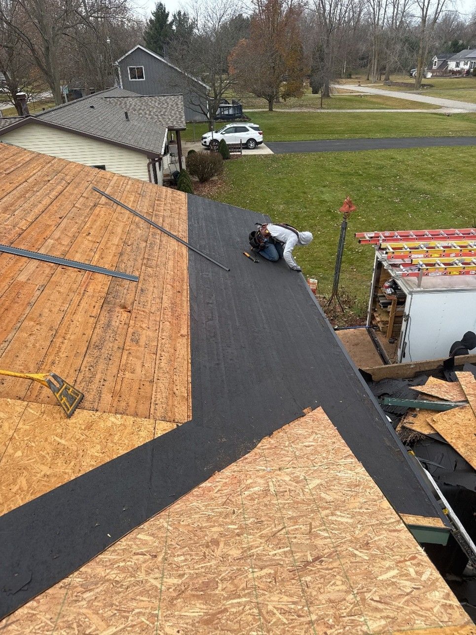 A roofing contractor working on professional roof repairs.