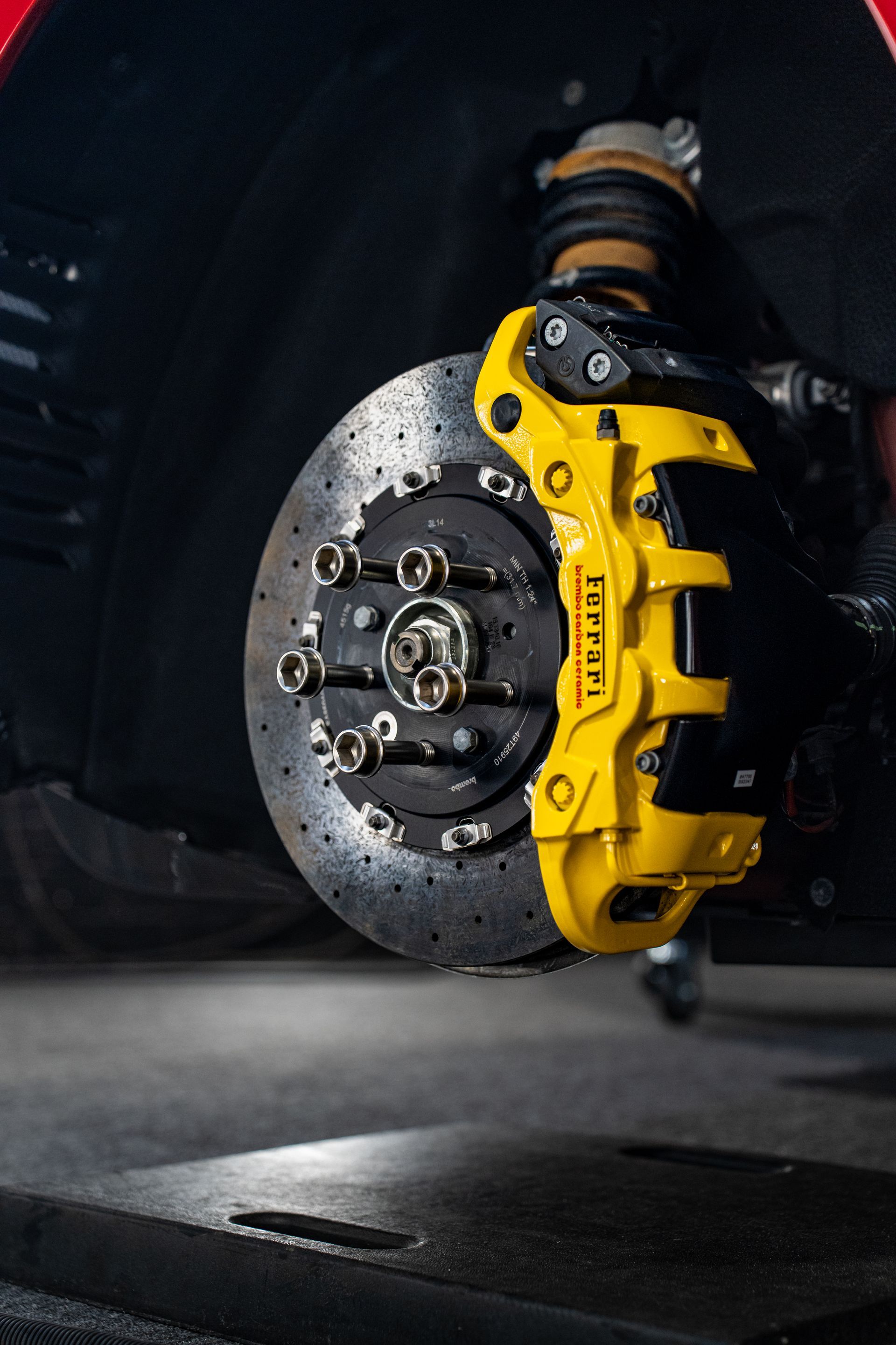 A close up of a yellow brake caliper on a car.