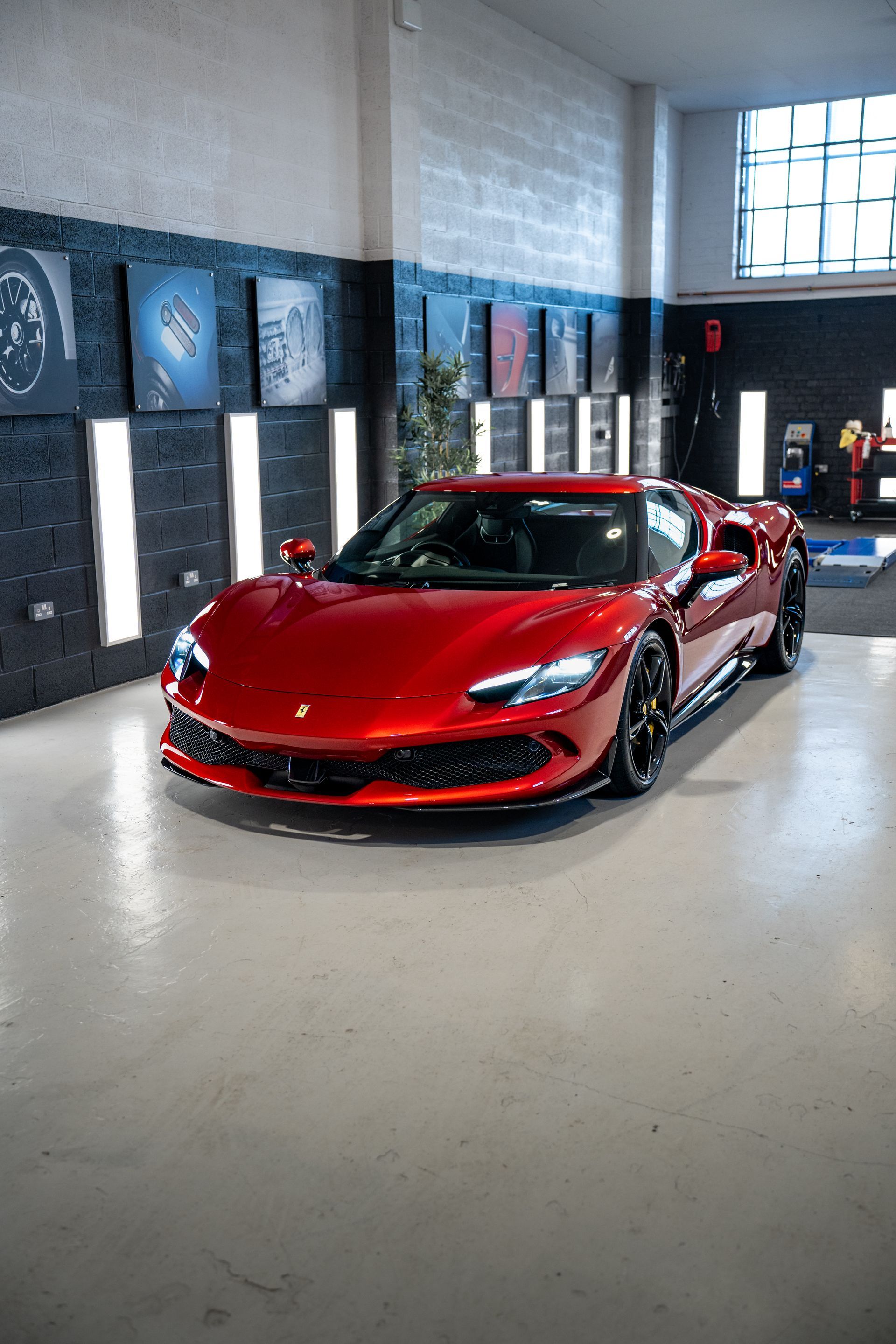 A red sports car is parked in a garage.