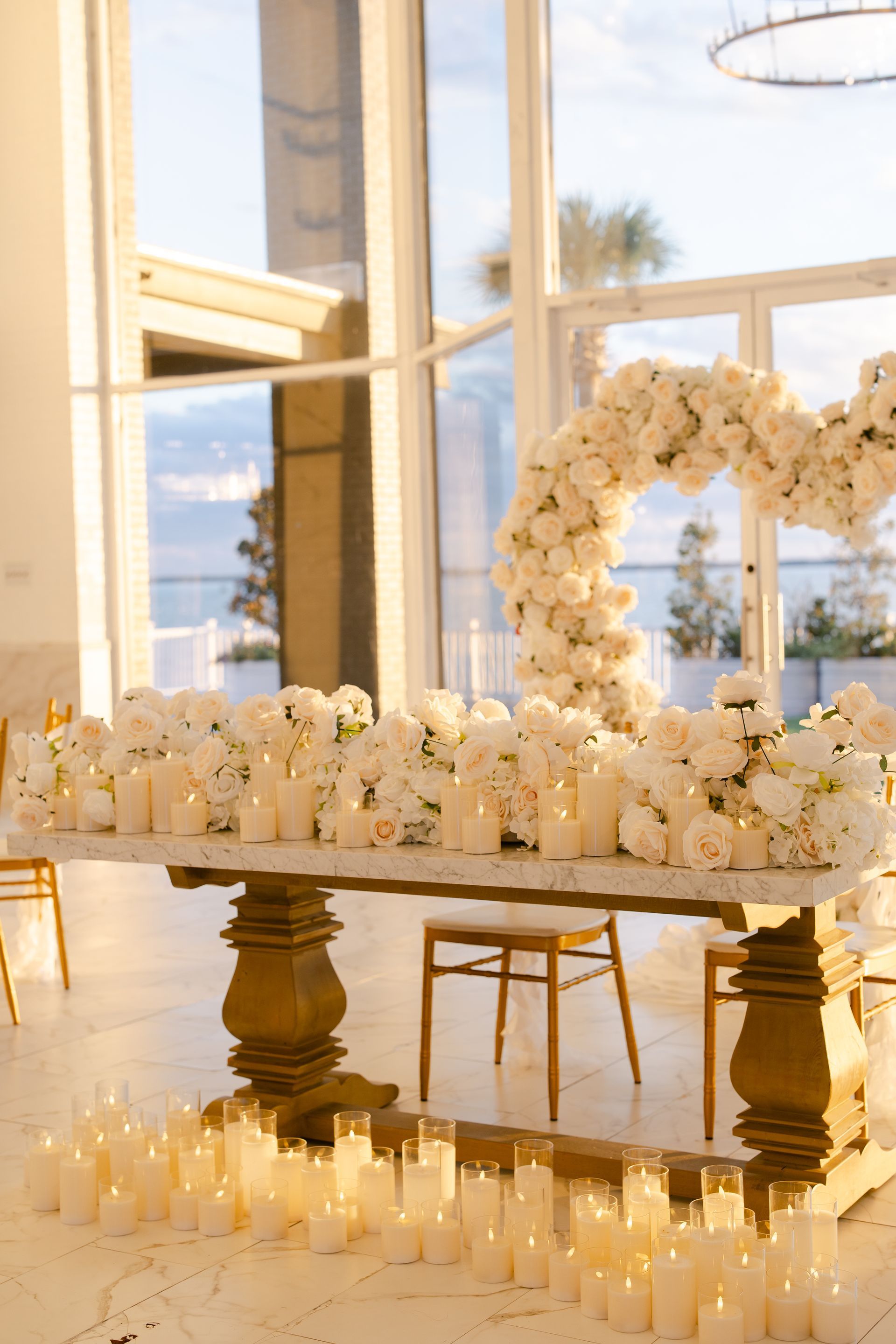 A table with candles and flowers on it in a room.