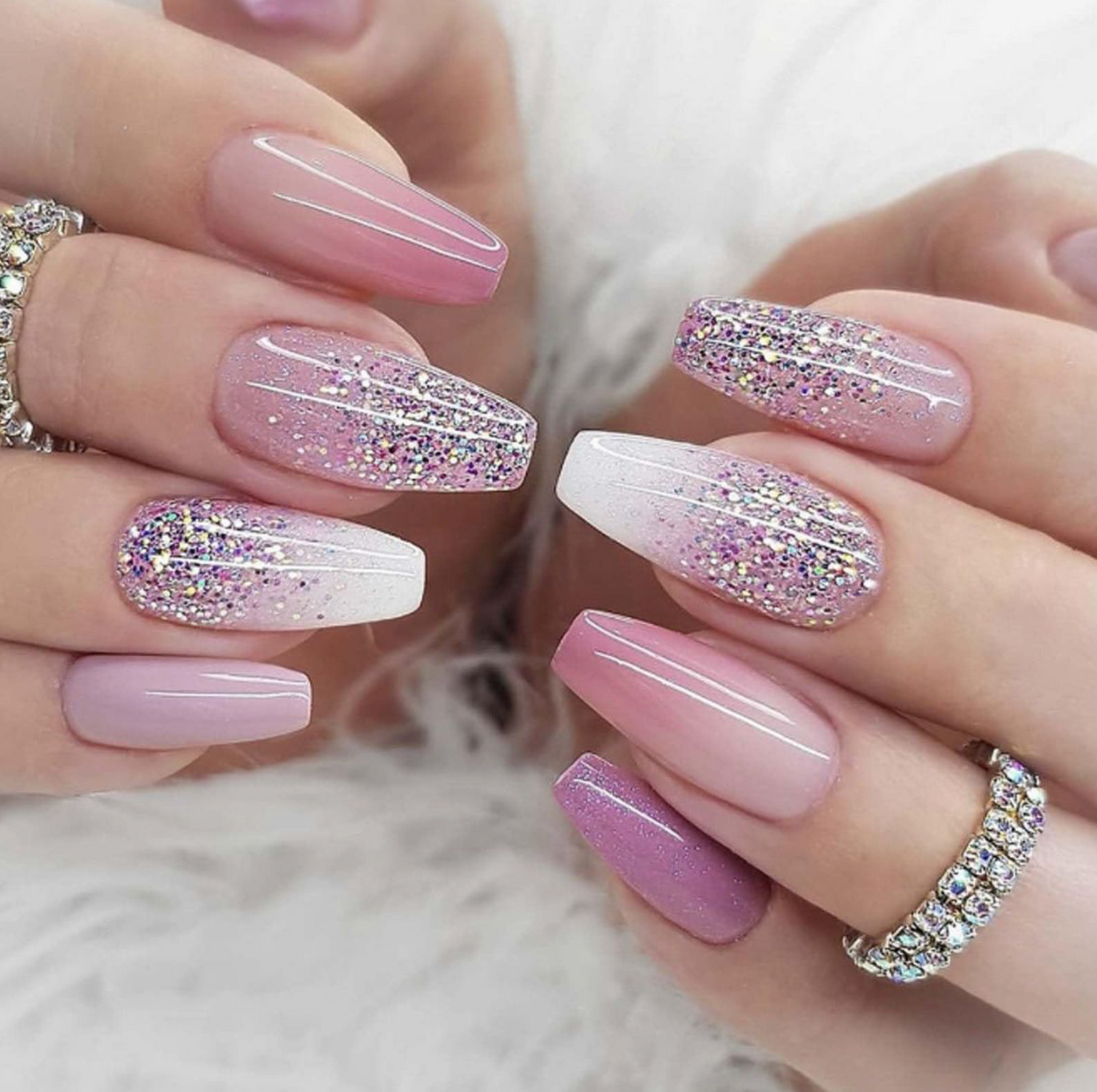 A close up of a woman 's nails with a ring on her finger.