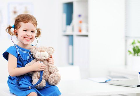 The Clinic of Pediatrics and GI Medicine — Child Smiling with Stuffed Toy in Panama City, FL